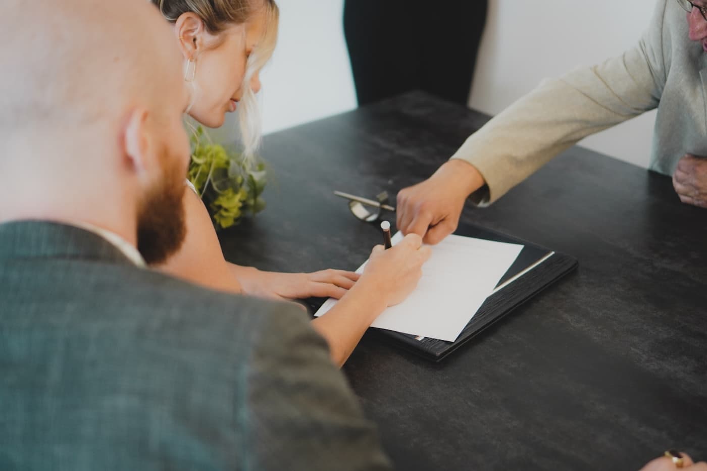 Couple signing documents together at a desk