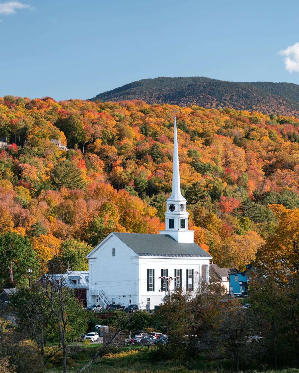 New England church steeple surrounded by autumn foliage