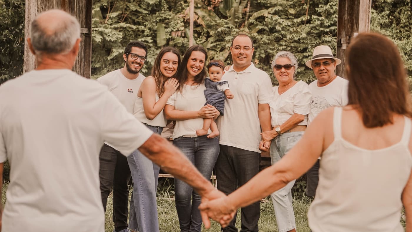 Family members joining hands together outdoors