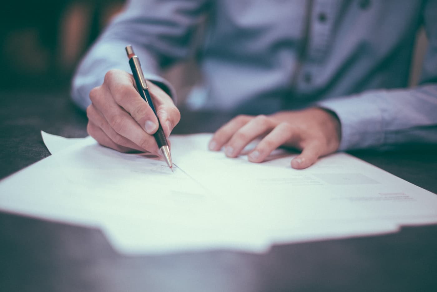Attorney reviewing and annotating a will at a desk